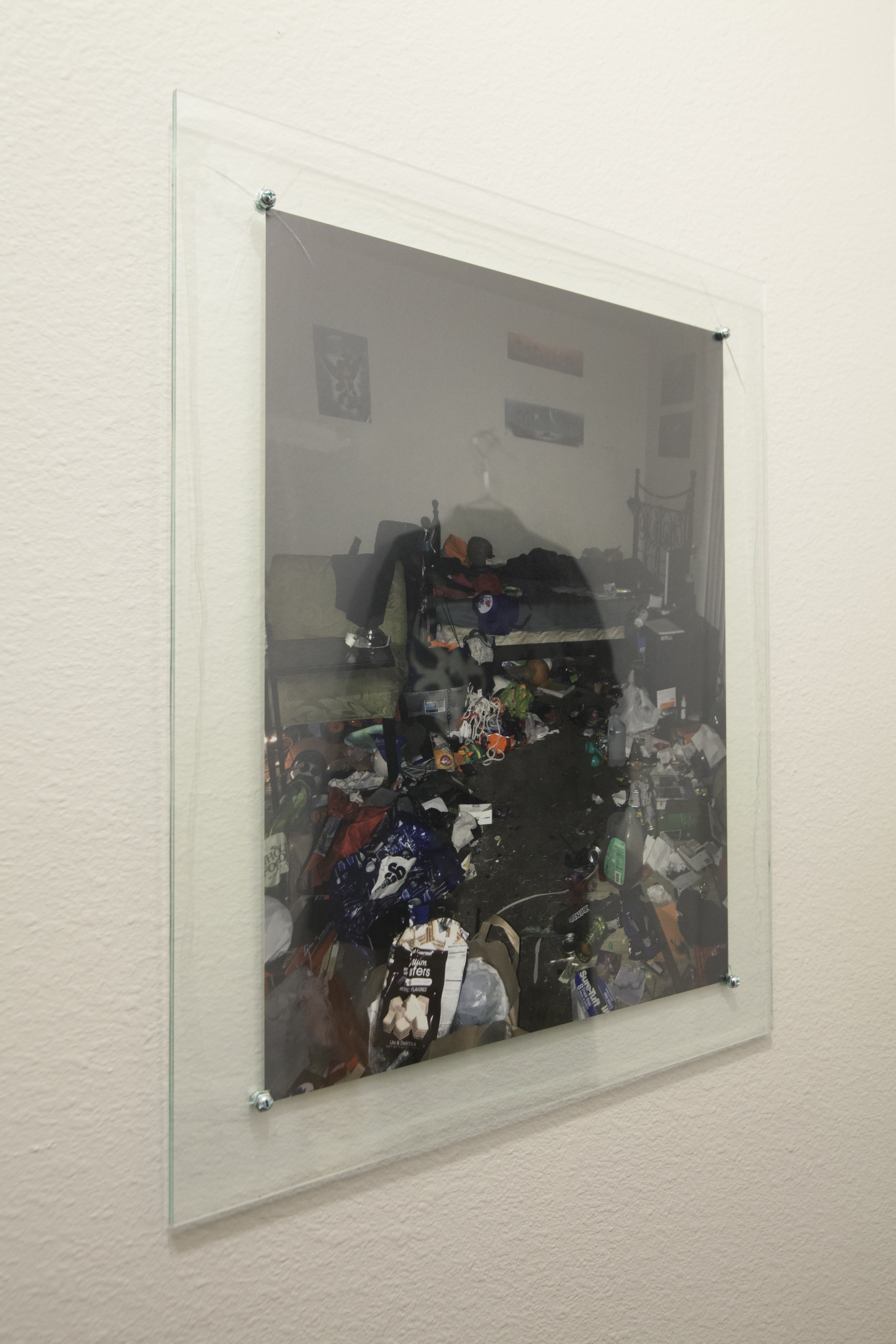 Photo print of a hoarder house hung on a white wall